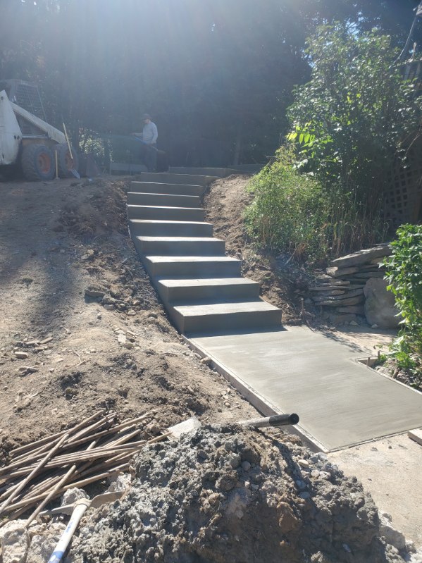 Hillside concrete steps being poured and finished on a sloped lot in the North Hills, PA