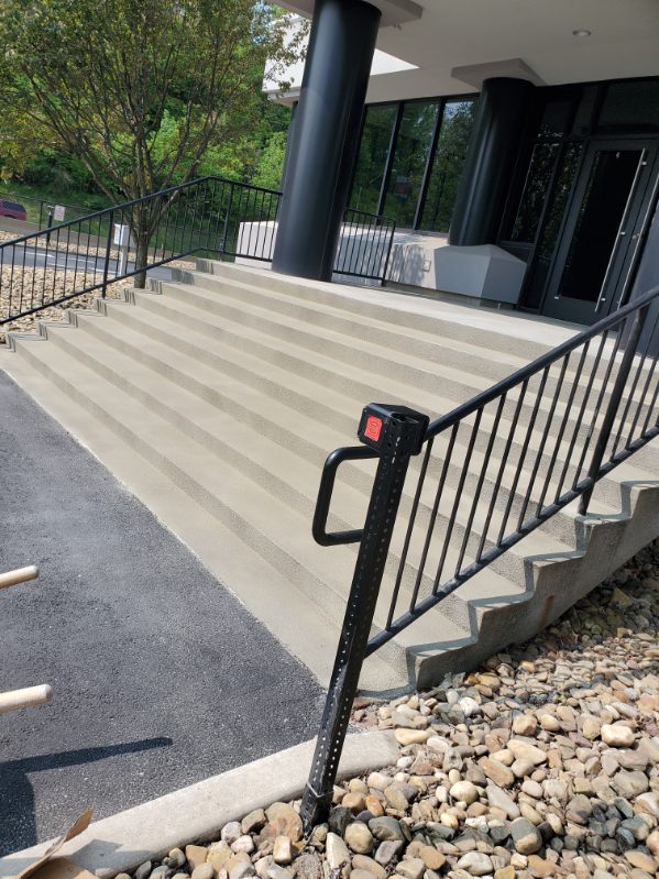 Wide commercial concrete entrance steps with metal railings near Pittsburgh, PA
