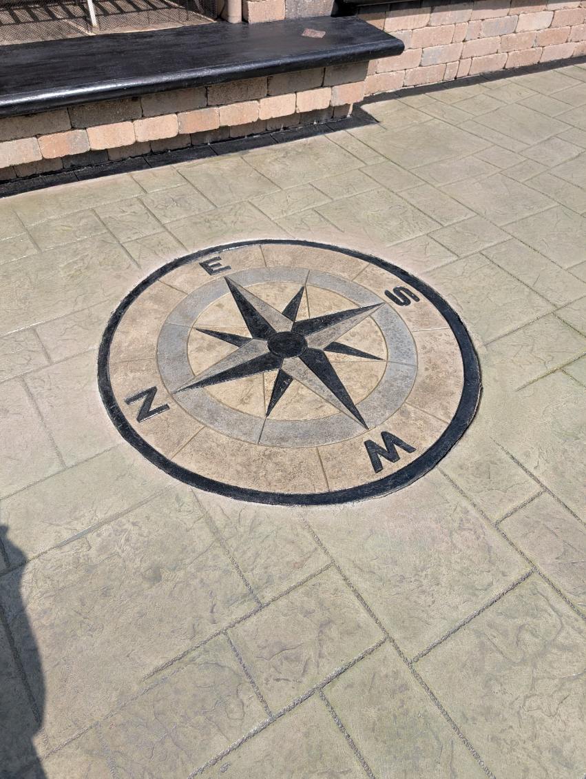 Decorative stamped concrete compass rose medallion set into a patio near Gibsonia, PA