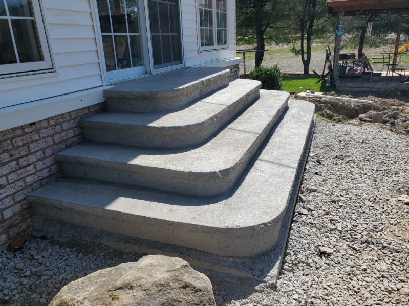 Curved stamped concrete steps leading to a back door in Allegheny County, PA