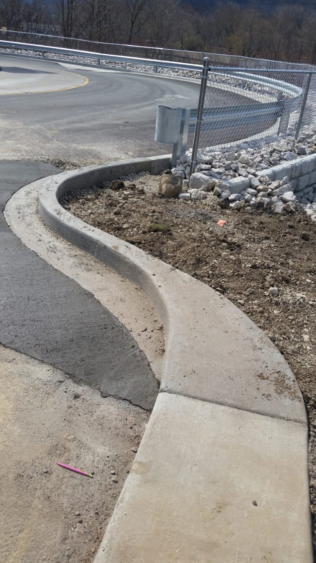 Finished curved concrete curb and gutter along a commercial roadway near Pittsburgh, PA
