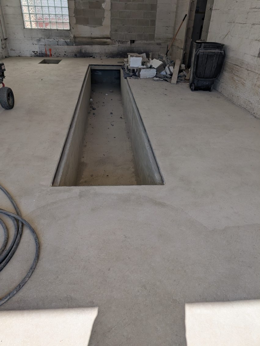 New interior concrete slab floor with trench drain formed in a commercial garage in Allegheny County, PA