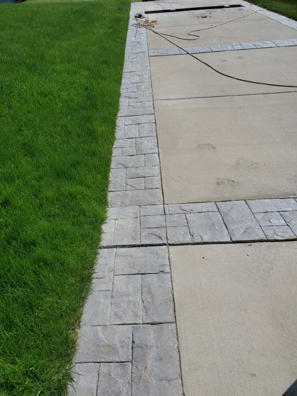 Concrete driveway with stamped stone border bands in the North Hills, PA